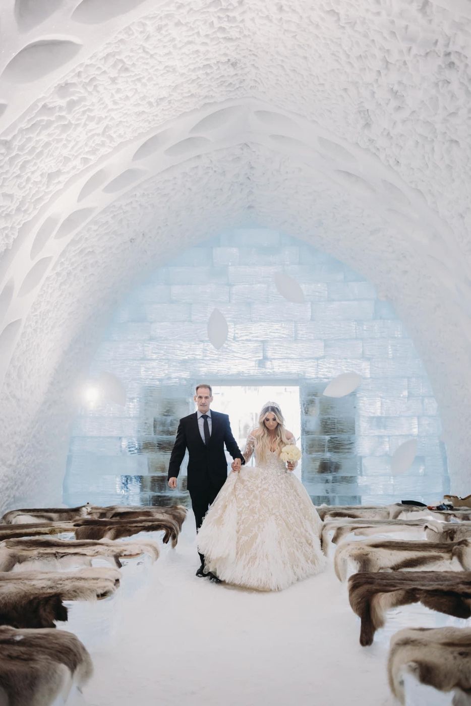 Charles walking his daughter down the aisle in the ice chapel